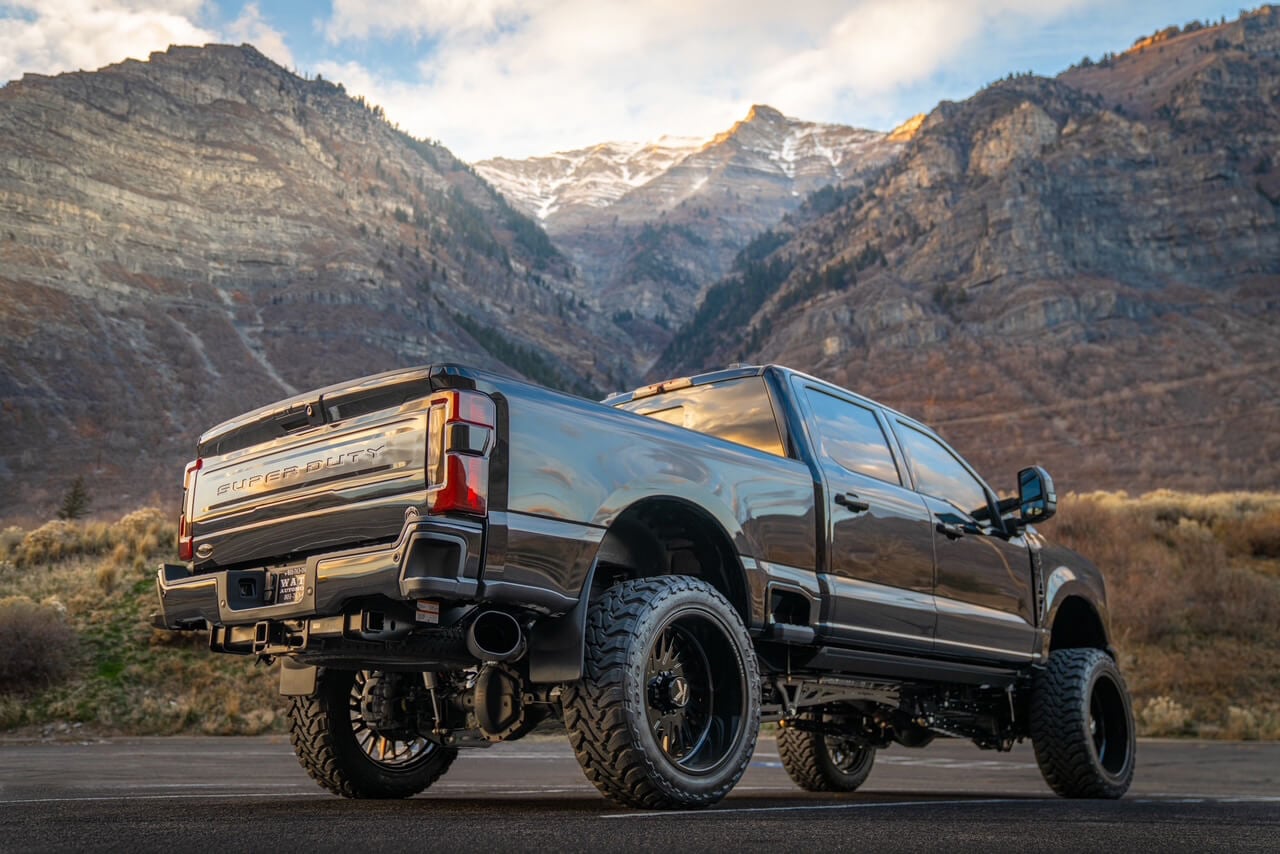 Rear view of custom lifted Ford Super Duty with aftermarket wheels and suspension by Watts Automotive
