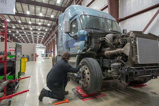 Picture of a truck in a service bay being worked on.