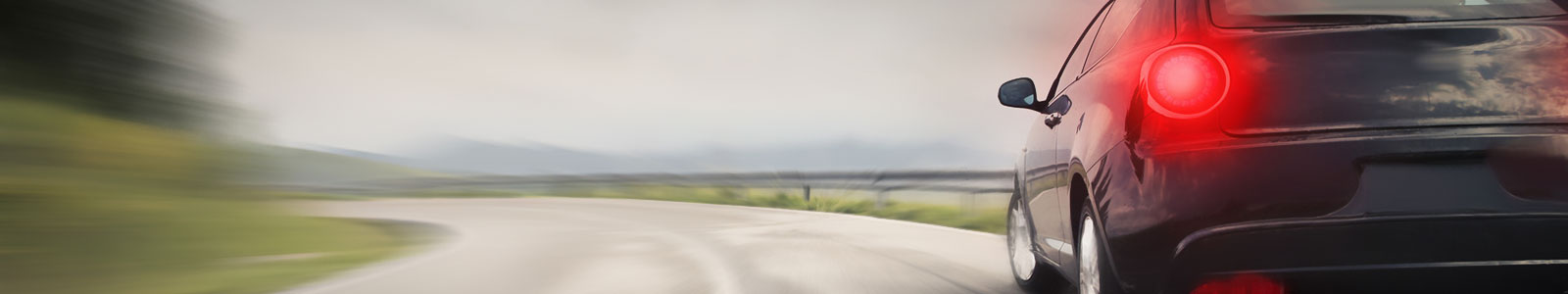 Black Car Driving Down Road