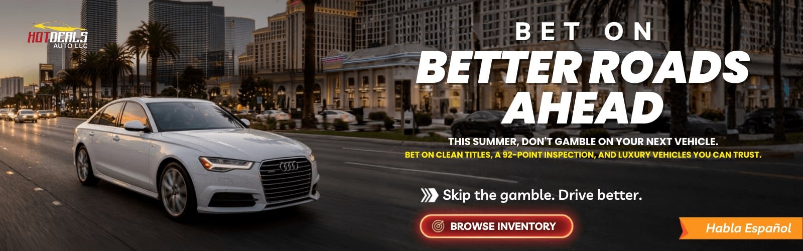 Luxury white Audi sedan driving on the Las Vegas Strip promoting quality pre-owned vehicles from Hot Deals Auto Las Vegas.