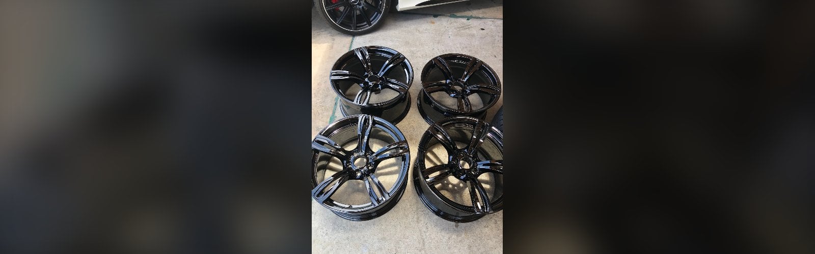 Set of four black alloy wheels removed from a vehicle for service in Delray Beach, FL