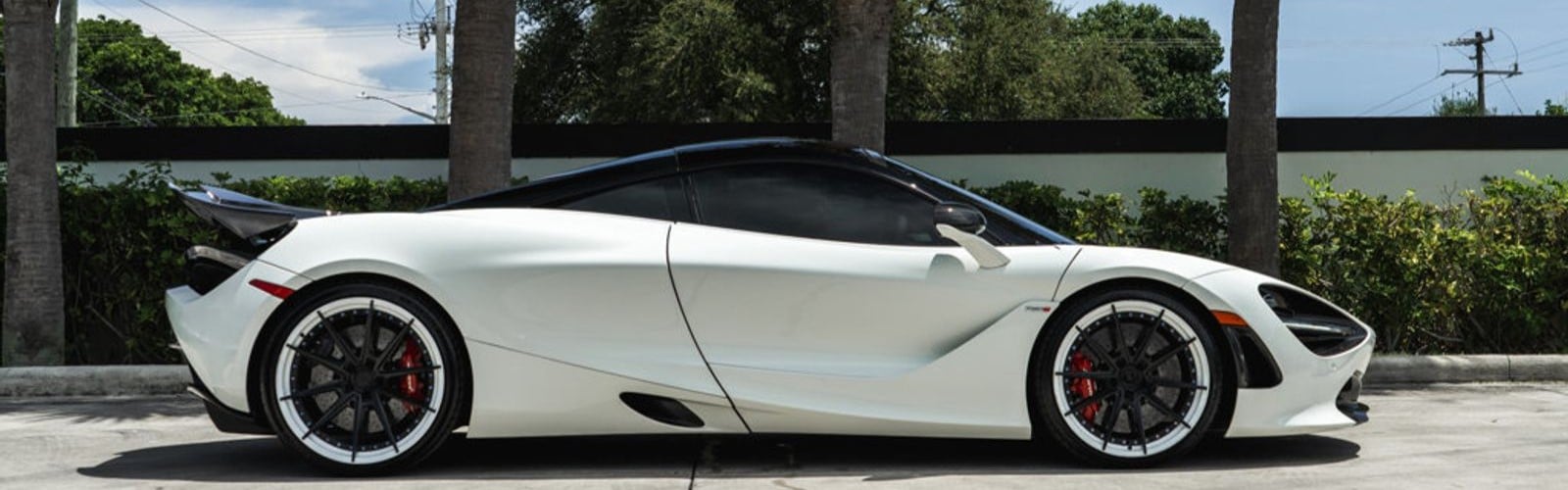 White McLaren 720S side profile at the Presidential Auto Sales and Service exotic car service center in Delray Beach, Florida
